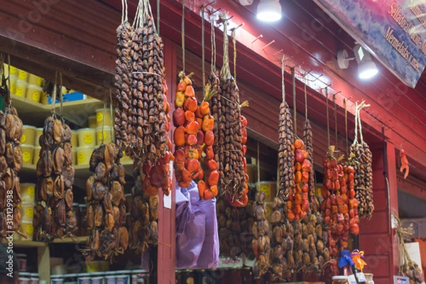 Obraz Caleta Angelmo - Puerto Montt, Chile / 17 February  - 2019: hanging seaweed and smoked or dried seafood at a stall in a local fish market