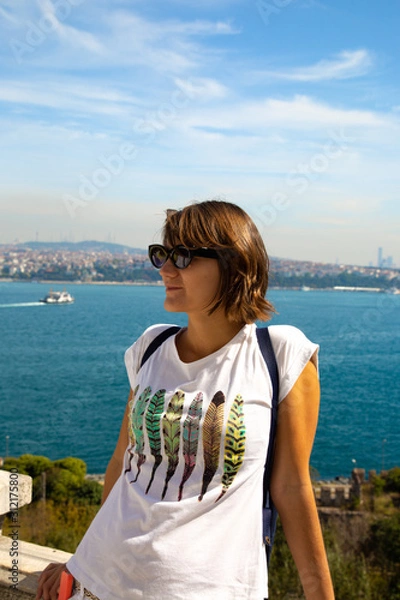Fototapeta Beautitiful woman traveller standing at the view point to Bosphorus bay in Istanbul Turkey.