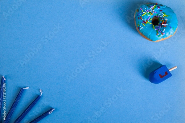 Fototapeta colorful doughnut dreidel candles blue background studio