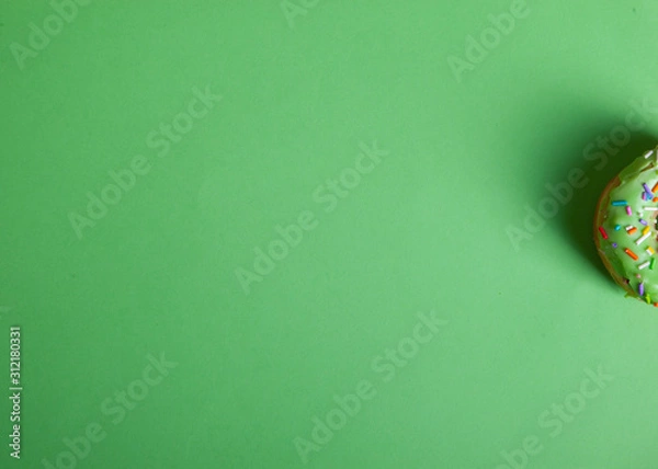 Fototapeta colorful doughnut green background studio