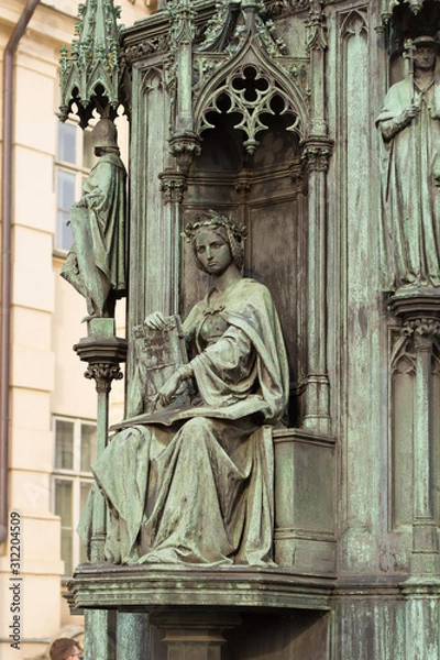 Fototapeta neo-gothic statue of woman holding book