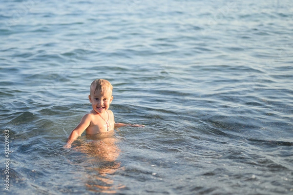 Obraz three year old little boy having fun at summer vacation in sea with his family