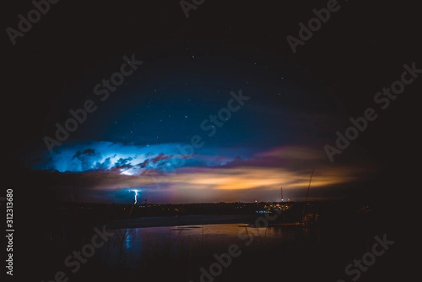 Fototapeta lightning over water