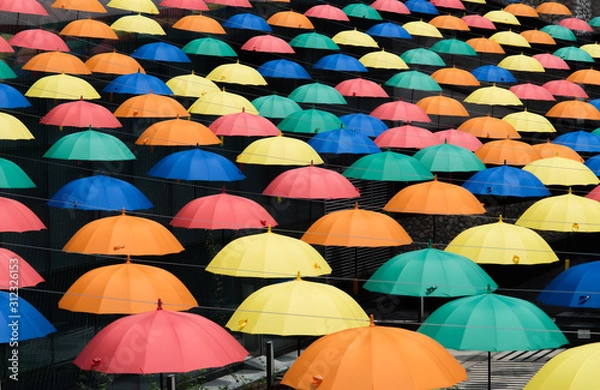 Obraz Colorful umbrellas background. Multicolored umbrellas hanging above the street. 