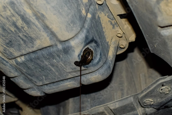 Obraz Drain the old oil from the engine through the drain plug