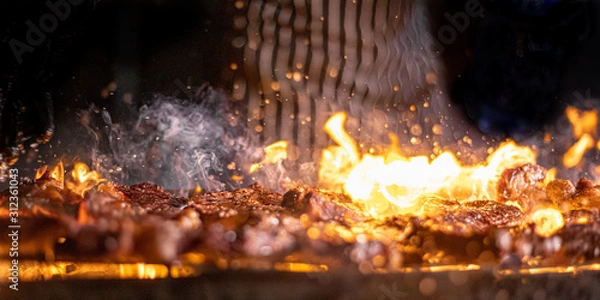 Fototapeta grilling meat on fire 