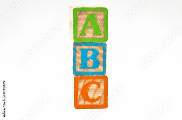 Fototapeta wooden cube blocks stacked with the letters abc isolated on a white background