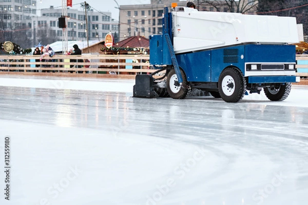 Fototapeta Ice resurfacing machine ,Ice resurfacer, resurfacing the ice rink in the central park of the town.