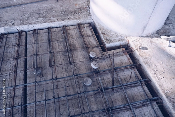 Fototapeta Deformed steel bars. Steel structure construction, structure of concrete for building bridge, Beautiful structure steel construction. ..A deformed steel bars frame inside concrete footing or floor