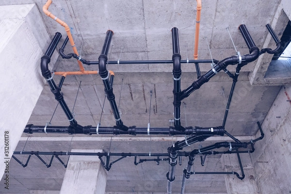 Fototapeta Water pipe engineering, clean line watering transport system in the building. Water pipe system. Construction work.Installation of water pipes in the building.Water pipe system within the building.