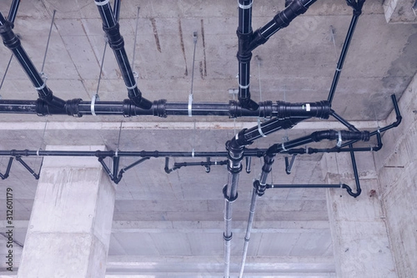 Fototapeta Water pipe engineering, clean line watering transport system in the building. Water pipe system. Construction work.Installation of water pipes in the building.Water pipe system within the building.