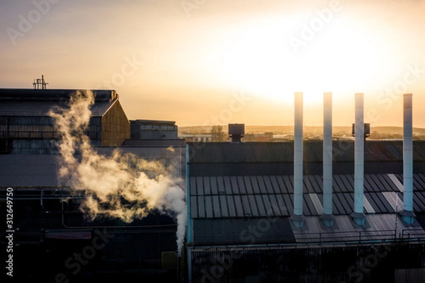 Fototapeta Sheffield city frosty golden sunrise. Aerial view looking over factories with steam from chimneys on a cold winters day in December 2019, South Yorkshire, UK