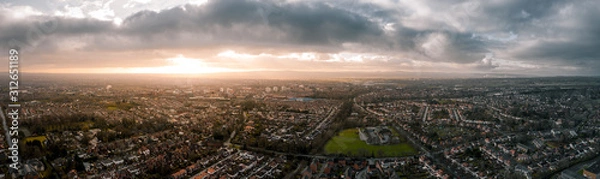 Fototapeta Beautiful Aerial Panorama of Chester at sunset in, Cheshire, UK. Christmas Day December 2019, showing residential buildings and a cloudy sky