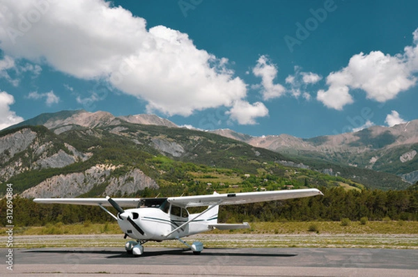 Obraz Single engine piston Cessna 172 parked at an airfield in the mountains
