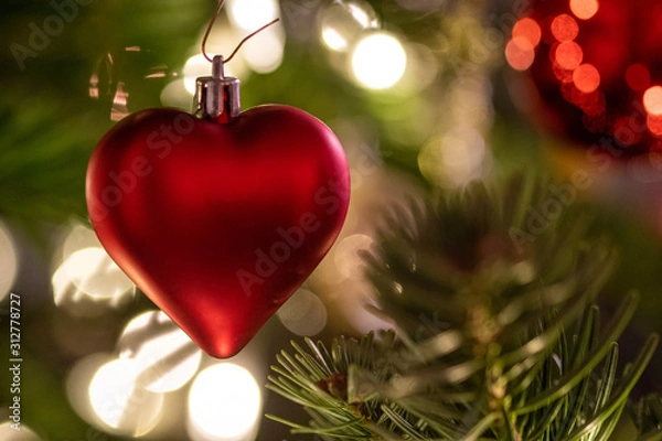 Fototapeta a red heart as christmas decoration on the christmas tree 2