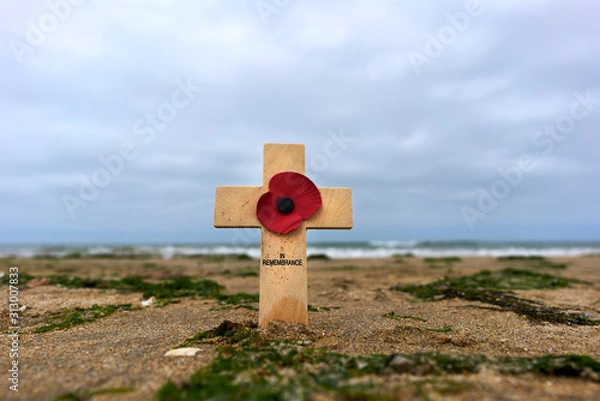 Obraz Wooden cross in the sand at Utah Beach in the Normandy to remember the deaths of the second world war