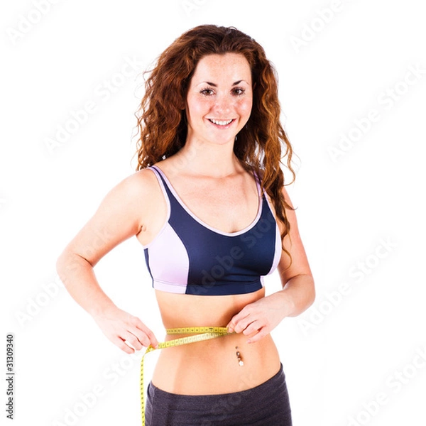 Fototapeta junge Frau misst ihre Taille