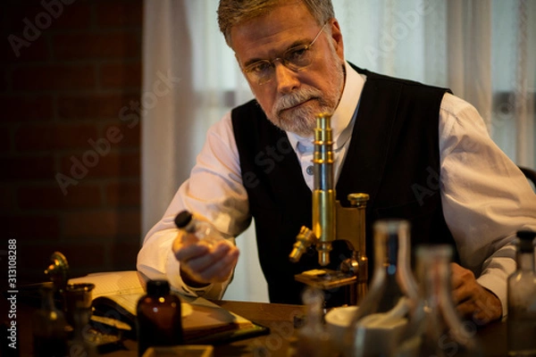 Obraz 1885 scientist thinking while holding a drug