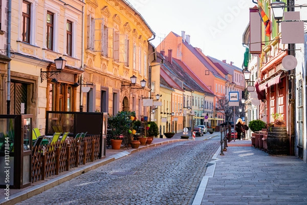 Obraz Street cafes with tables and chairs in Ptuj old town center in Slovenia. Architecture and restaurants in Slovenija. Travel