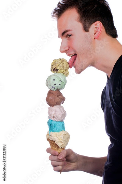 Fototapeta Young man eats a six scoop ice cream cone.