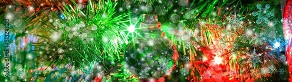 Fototapeta Snowflake New Year winter pattern on blurred defocused background of evergreen tree branch and toys