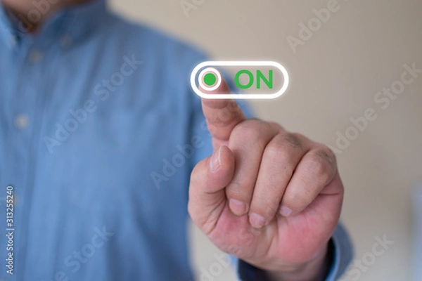 Fototapeta Businessman slides on off switch to on position, positive reaction