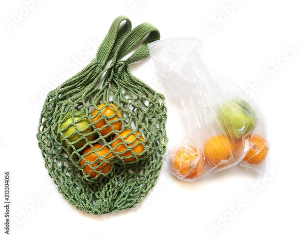 Fototapeta Green Hand-Made Crochet Eco-Friendly String Shopping Bag with Green Apples and Tangerines  VS Plastic Bag on White Background Flat Lay. Concept of Ecology, Environmental Protectio                     