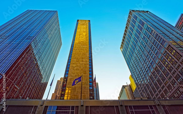 Fototapeta Bottom up Street view on Financial District of Lower Manhattan, New York City, NYC, USA. Skyscrapers tall glass buildings United States of America. Blue sky on background. Empty place for copy space.