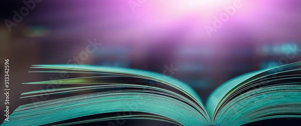 Fototapeta Stack of books in the library and blur bookshelf background	