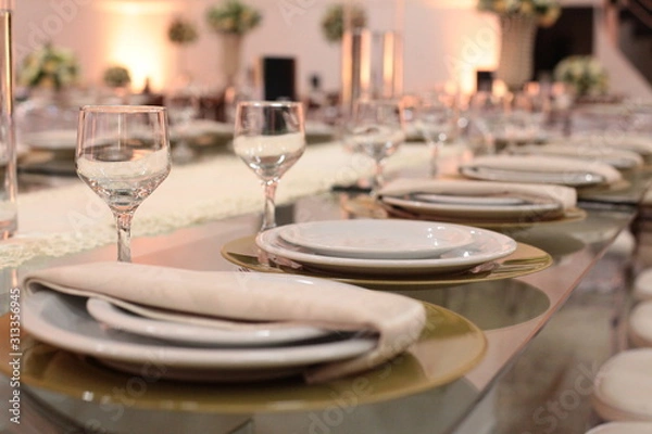 Fototapeta Table setting with glasses, plates, napkins and food