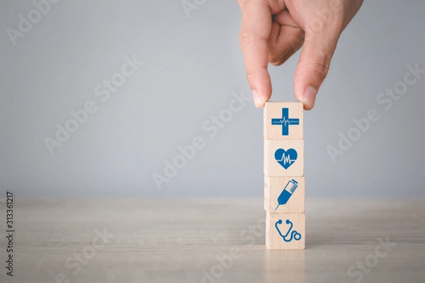 Fototapeta Health Insurance Concept,hand arranging wood block stacking with icon healthcare medical.