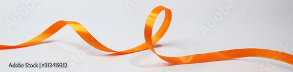 Obraz Orange ribbon isolated on white background