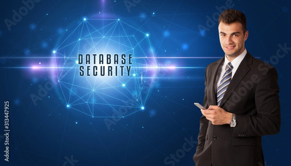 Fototapeta Businessman thinking about security solutions with DATABASE SECURITY inscription
