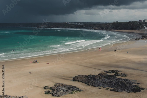 Obraz Large beach with groups of people and stormy sky