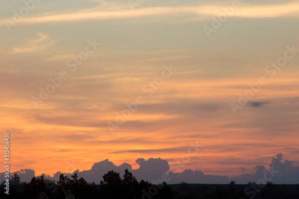 Obraz evening sky with clouds lit by the setting sun