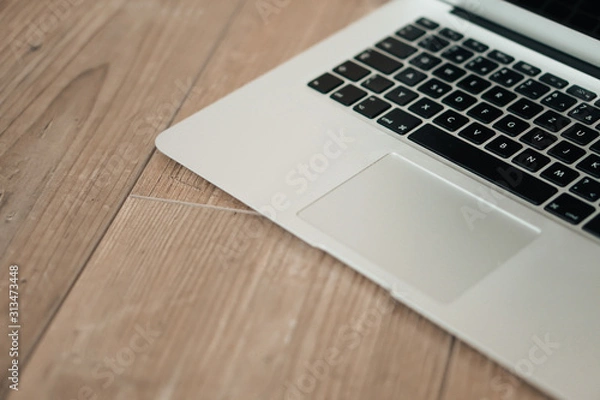 Fototapeta Overhead of modern comfort work place. Different objects on wooden background.