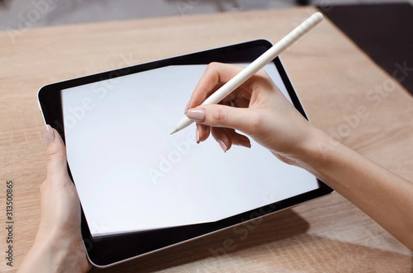 Obraz Girl using stylus on tablet to draw