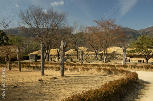 Obraz Old korean town in Suncheon, South Korea. The town have many  grass-roofed house of  the age of Joseon Dynasty. You can see wood guardians of the town.