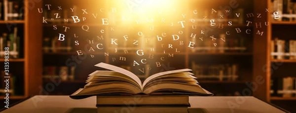 Obraz 	 The concept of education by planting a tree of knowledge in the opening of an old book in the library and the magical magic of light that flies to the destination of success. Beautiful background