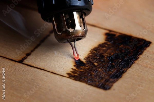Fototapeta Pyrography. Wood burning with pyrography pen. Close up