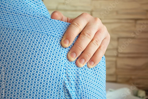 Fototapeta Person grabbed shoulder with palm of his other hand because of intense pain in it. Concept photo of shoulder pain syndrome, frozen shoulder, periartrosis, nerve pinching, arthrosis that occur suddenly