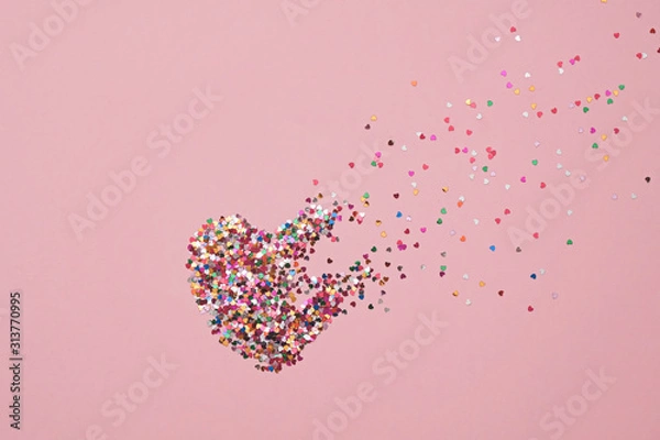 Fototapeta Valentine day composition with broken heart made from confetti on pink background