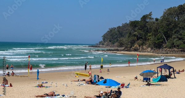 Fototapeta beach with umbrellas and sunbeds