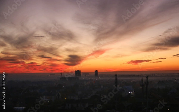 Fototapeta Countryside. Pink sky in the rays of the setting sun.