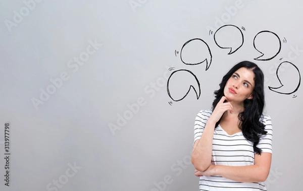 Fototapeta Speech bubbles with young woman in a thoughtful face