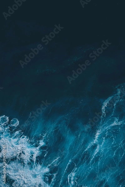 Fototapeta Aerial view to sea landscape, water with waves and rocks. Dramatic colors photo. Image with place for text.