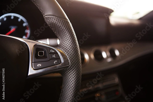 Fototapeta Control buttons on the steering wheel of a car