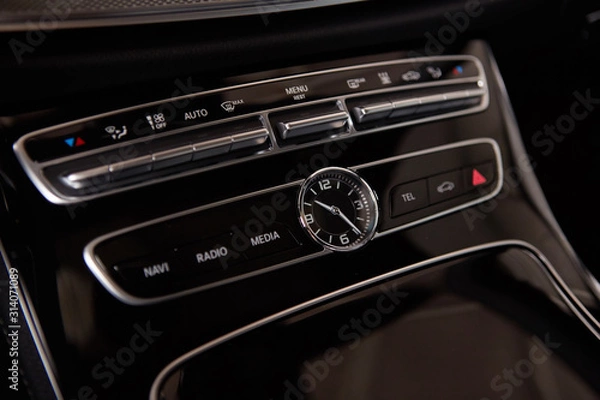 Fototapeta Luxury car interior details. Middle console with air and multimedia controls