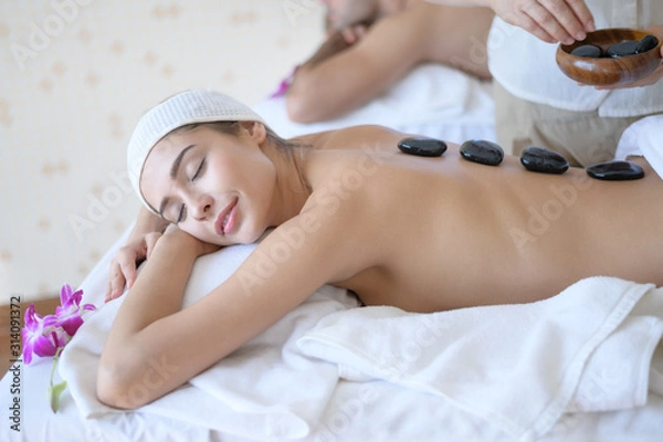 Obraz A beautiful woman slept with eyes and massage the face and head at the spa.