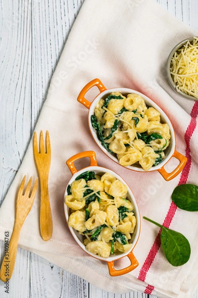 Fototapeta Spinach Mac and Cheese on Wooden Background. Selective focus.